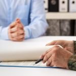 Service member signing a statement in a conference room with attorney; what to do when you are the subject of a command investigation